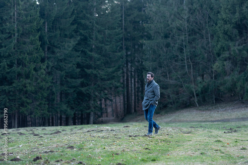 Young man walking in the woods	