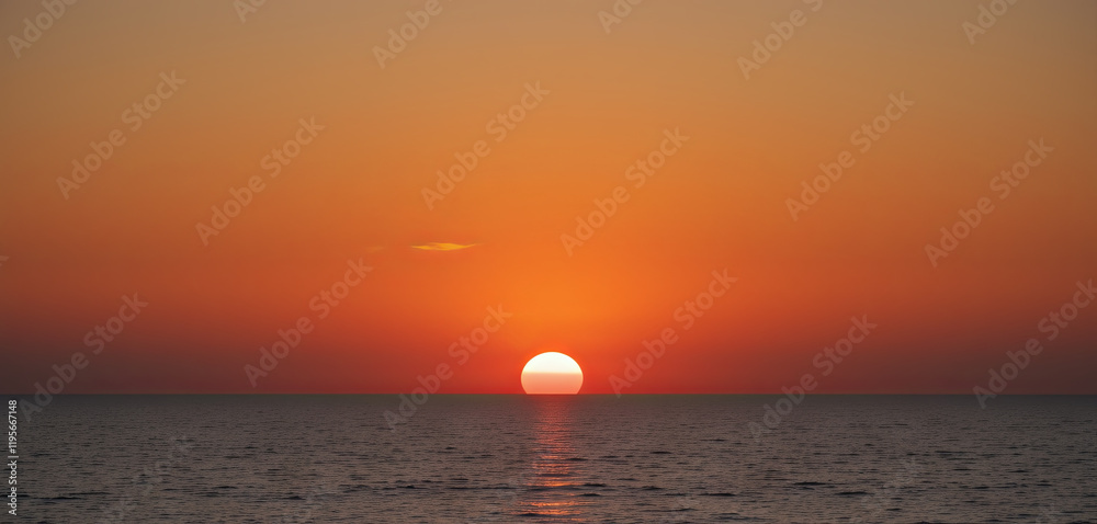 Vibrant colors fill the sky as the sun sets slowly over the tranquil ocean. The horizon glows with shades of orange and yellow, creating a serene atmosphere Vibrant colors fill the sky as the sun sets slowly over the tranquil ocean. The horizon glows with shades of orange and yellow, creating a serene atmosphere