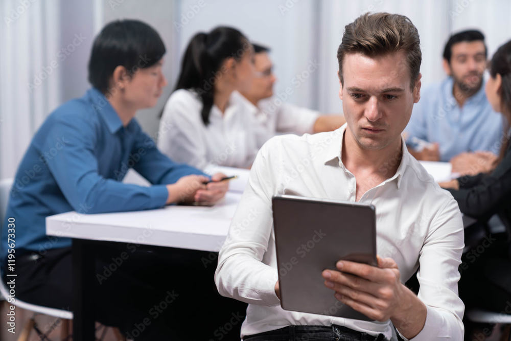 Confidence and happy smiling businessman portrait with background of his colleague and business team working in office. Office worker teamwork and positive workplace concept. Prudent
