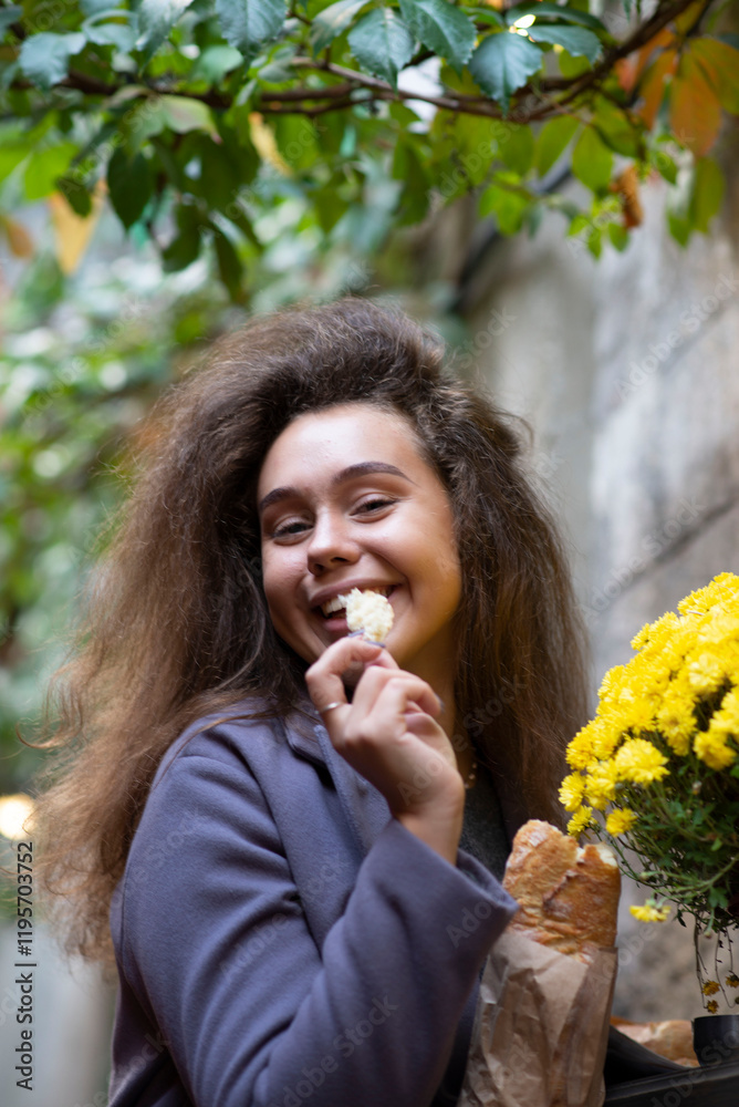 The girl is eating a baguette The girl is eating a baguette