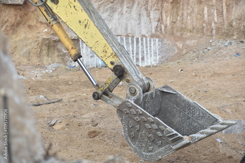 BIG JCB MACHINE CUTTING THROUGH STONE, ROCKS and SOIL photo