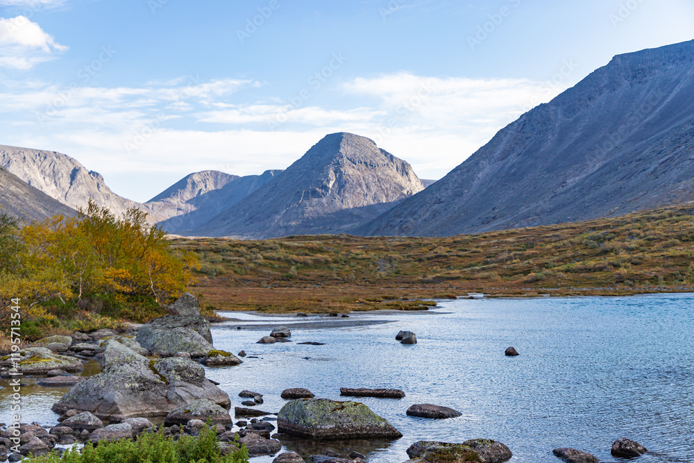 View to Petrelius river valley at Khibiny mountains. Early autumn in arctic tundra region. Kola peninsula, Murmansk region, Russia. View to Petrelius river valley at Khibiny mountains. Early autumn in arctic tundra region. Kola peninsula, Murmansk region, Russia.