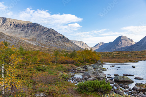 Obraz na płótnie View to Petrelius river valley at Khibiny mountains. Early autumn in arctic tundra region. Kola peninsula, Murmansk region, Russia. w salonie