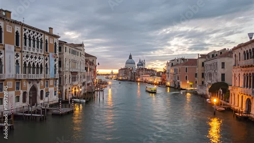 Night to day transition time lapse Grand Canal traffic and Basilica di Santa Maria della Salute, view from Accademia bridge, Venice, Italy