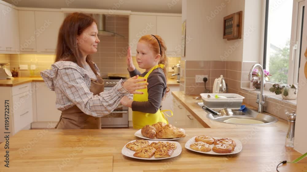 Baking pastries together in a cozy kitchen with mother and daughter