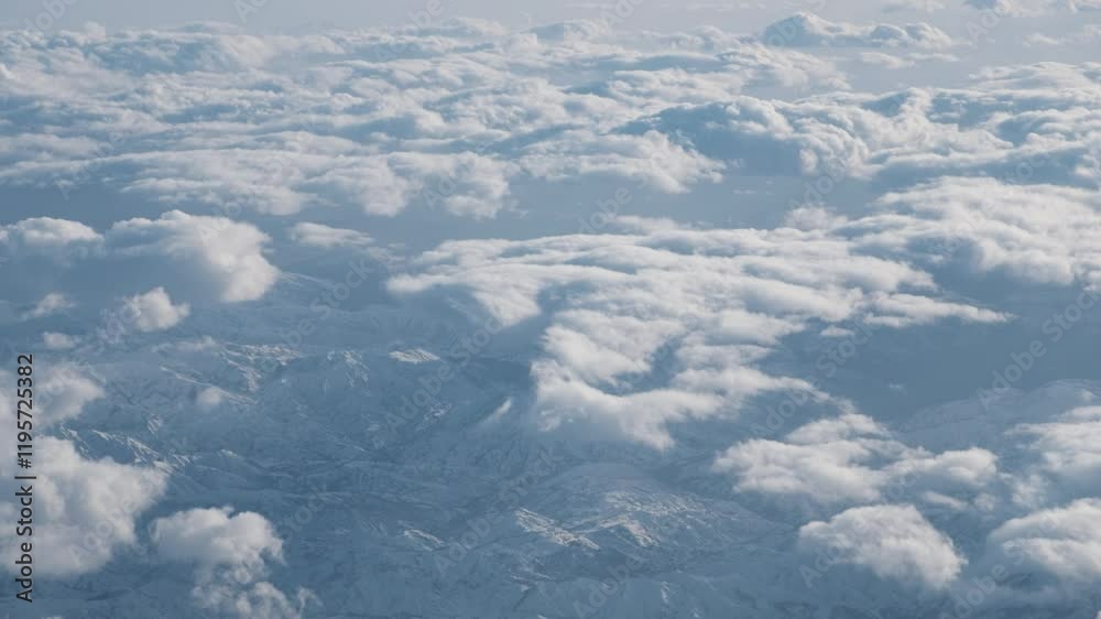 An enchanting aerial video capturing the breathtaking view of thick, fluffy clouds stretching endlessly below, seen from a plane window during a peaceful flight under a clear blue sky
An enchanting aerial video capturing the breathtaking view of thick, fluffy clouds stretching endlessly below, seen from a plane window during a peaceful flight under a clear blue sky