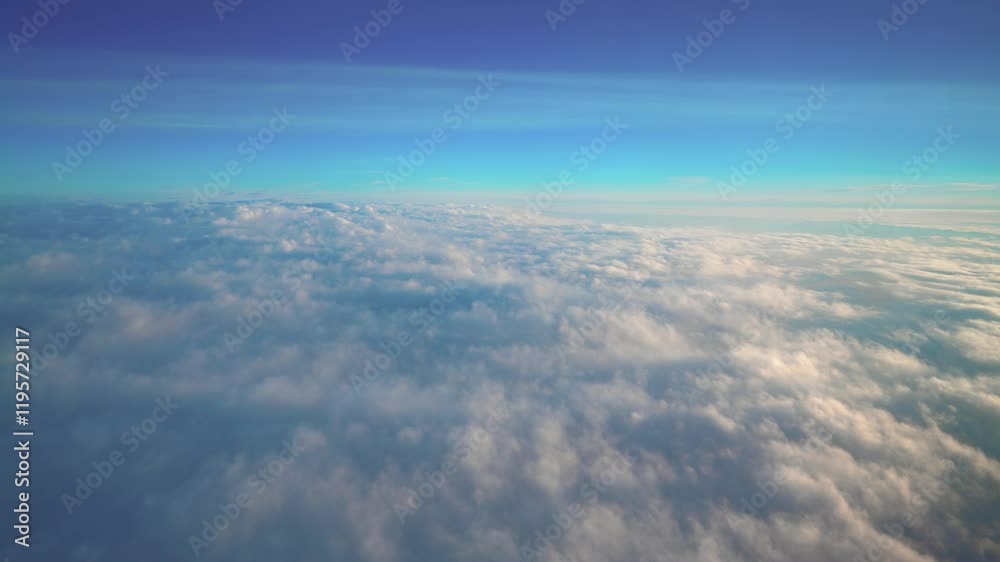 An enchanting aerial video capturing the breathtaking view of thick, fluffy clouds stretching endlessly below, seen from a plane window during a peaceful flight under a clear blue sky
An enchanting aerial video capturing the breathtaking view of thick, fluffy clouds stretching endlessly below, seen from a plane window during a peaceful flight under a clear blue sky