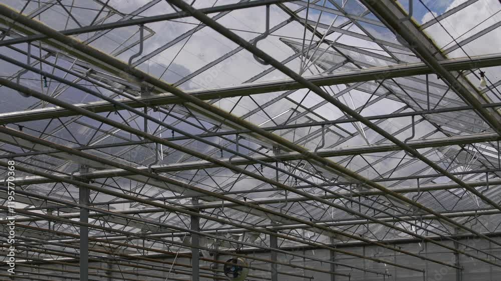 A large building with a lot of windows and a metal roof. The roof is very high and the windows are very large A large building with a lot of windows and a metal roof. The roof is very high and the windows are very large