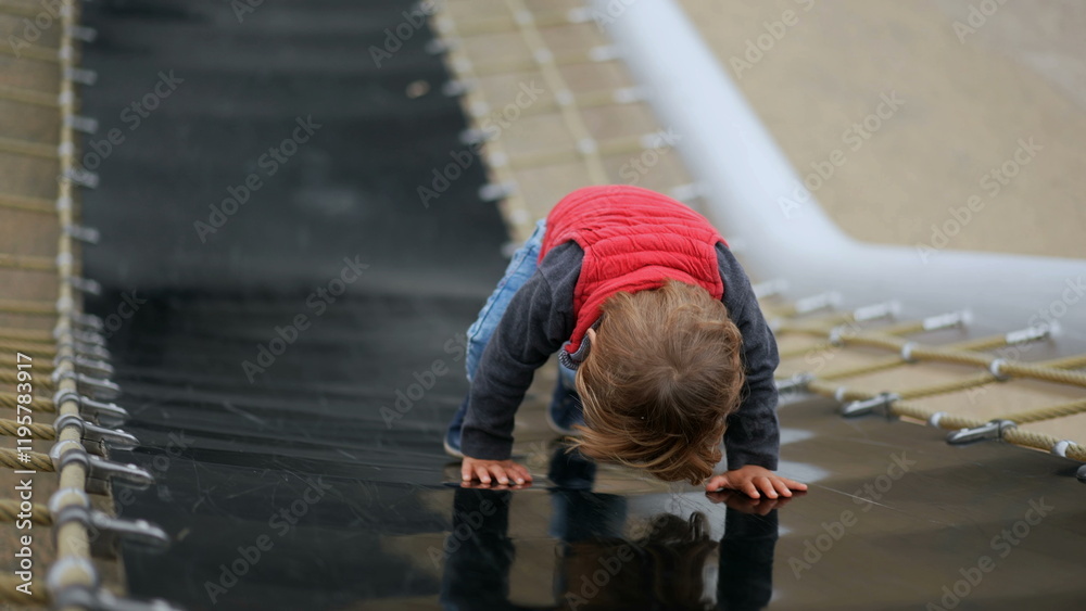 Active little baby boy toddler at playground park climbing slider Active little baby boy toddler at playground park climbing slider