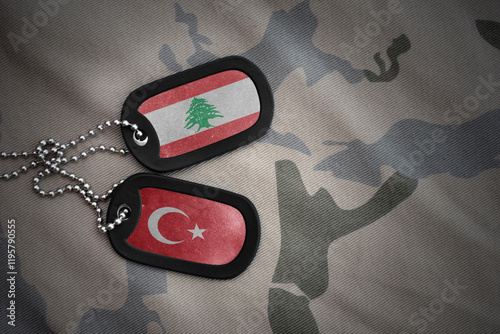 vintage army blank, dog tag with flag of lebanon and turkey on the khaki texture background. military concept. photo