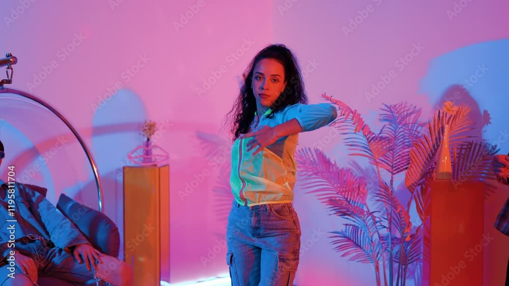 Hispanic hipster wear colorful cloth and waving to freestyle music. Professional break dancer moving to lively beat with neon light and led light with modern studio surrounded by friend. Regalement. Hispanic hipster wear colorful cloth and waving to freestyle music. Professional break dancer moving to lively beat with neon light and led light with modern studio surrounded by friend. Regalement.