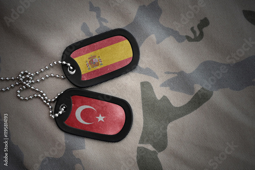 vintage army blank, dog tag with flag of spain and turkey on the khaki texture background. military concept. photo