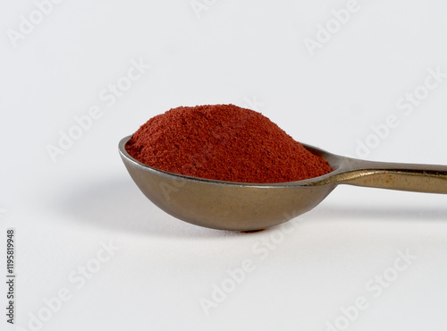 Fototapeta Naklejka Na Ścianę i Meble -  saffron powder on a silver spoon, white background, lots of detail, macro photo, photo opposite