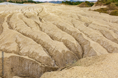 Romania, Buzau County, Berca. Botanical reservation Vulcanii Noroiosi de la Paclele Mici. Small volcano-shaped structures caused by eruption of natural gases. photo