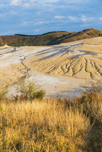 Romania, Buzau County, Berca. Botanical reservation Vulcanii Noroiosi de la Paclele Mici. Small volcano-shaped structures caused by eruption of natural gases. photo