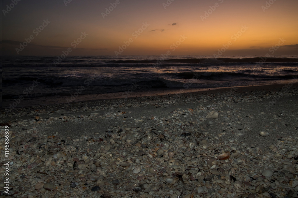 Sunset on the sea shell filled beach of Sanibel Island.