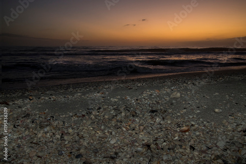 Sunset on the sea shell filled beach of Sanibel Island.
