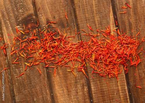 red safflower on a wooden table photo