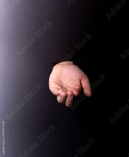 photo Mysterious hand emerging through dark void evokes curiosity, secrecy, intrigue, and mystery, invoking thoughts of connection, reach, offer, and the unseen.