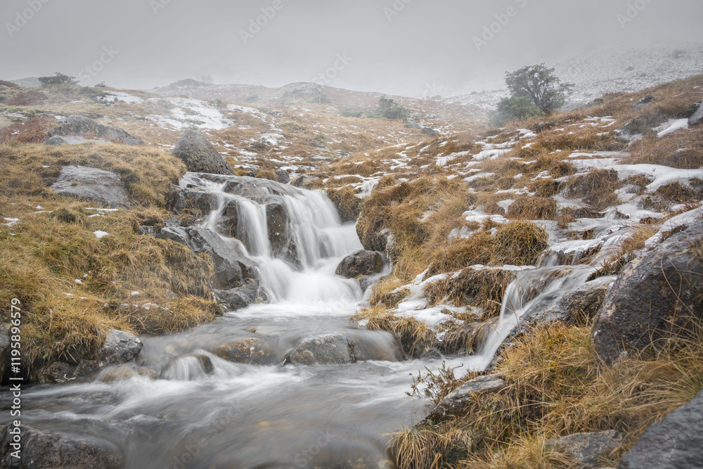 Thawing ice flowing into a waterfall in the Lake District Thawing ice flowing into a waterfall in the Lake District