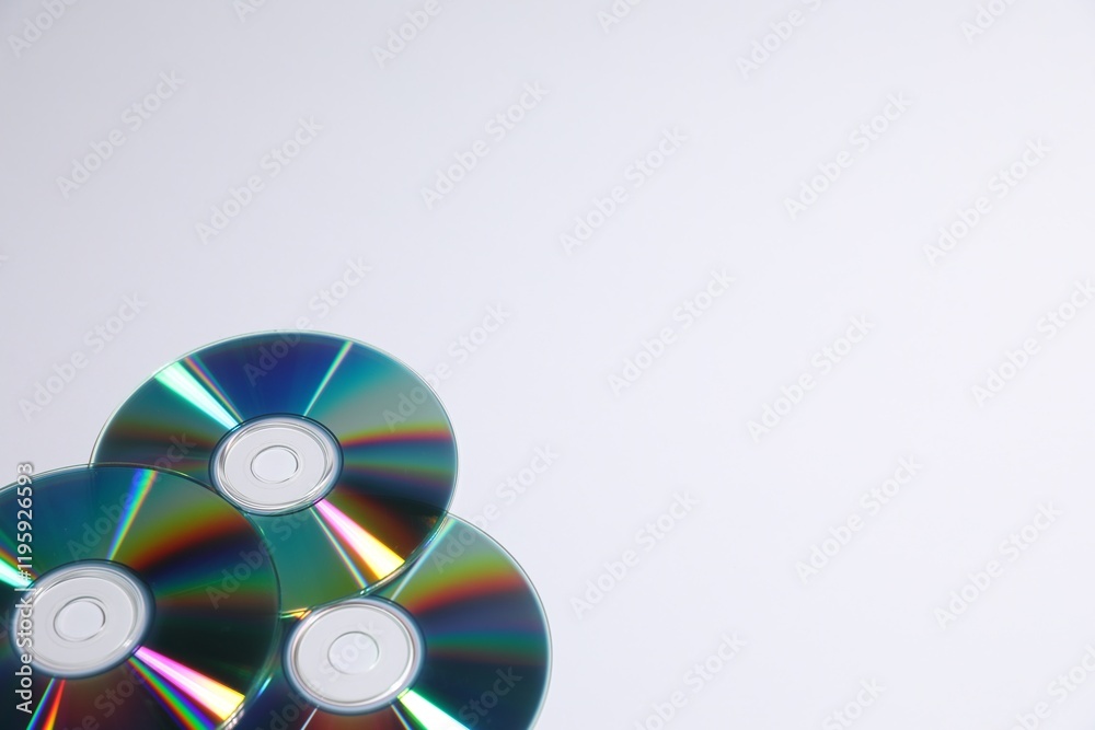 Many shiny compact discs on light background. Space for text Many shiny compact discs on light background. Space for text