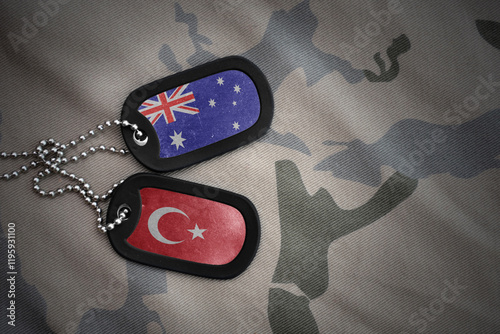 vintage army blank, dog tag with flag of australia and turkey on the khaki texture background. military concept. photo