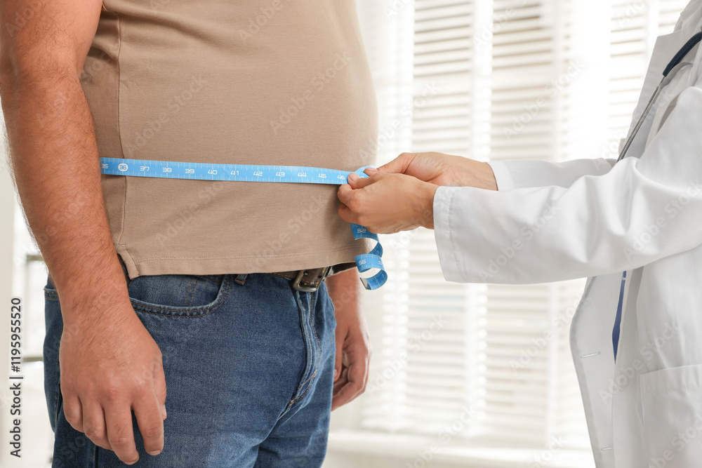 Φωτογραφία Nutritionist measuring overweight man's waist with tape in clinic, closeup