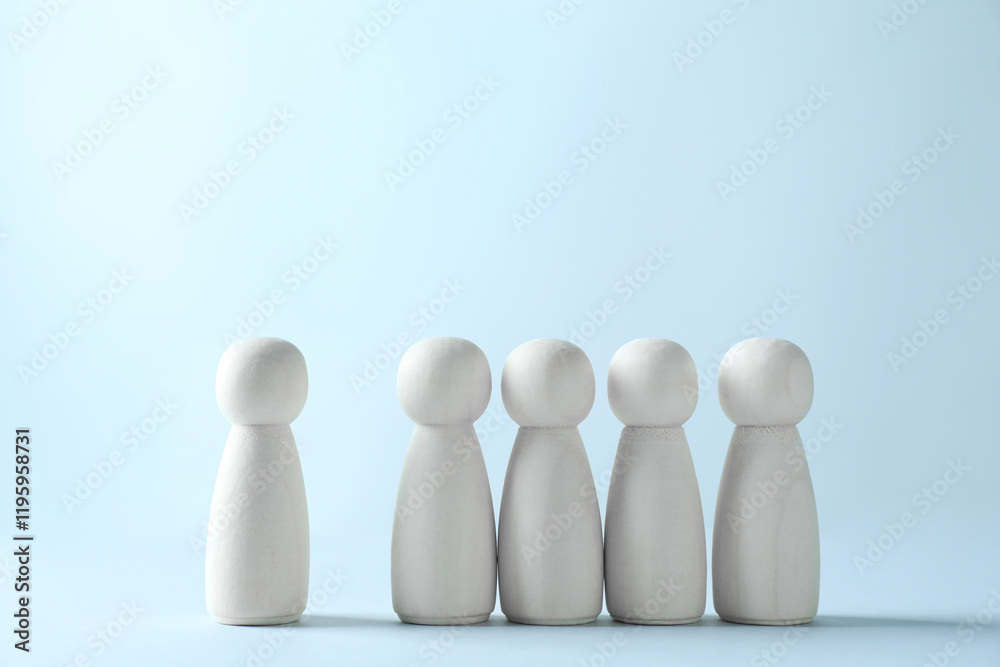 Human resources concept. Many wooden figures on light background, closeup. Space for text Human resources concept. Many wooden figures on light background, closeup. Space for text