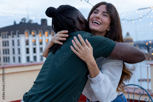 Friends Hugging and Smiling at a Rooftop Party Celebration photo