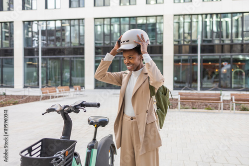 Black woman preparing for urban biking in stylish attire photo