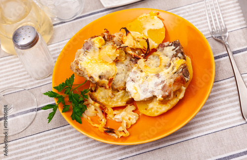 Appetizing pork with cheese and boiled potatoes on a plate photo