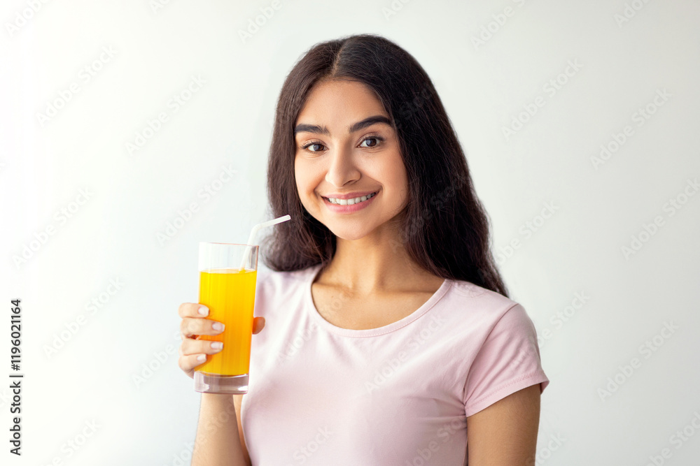 Pretty Indian woman drinking fresh fruit juice, enjoying detox beverage at home, copy space. Slim Eastern lady having tasty drink indoors. Healthy living and wellbeing concept Pretty Indian woman drinking fresh fruit juice, enjoying detox beverage at home, copy space. Slim Eastern lady having tasty drink indoors. Healthy living and wellbeing concept