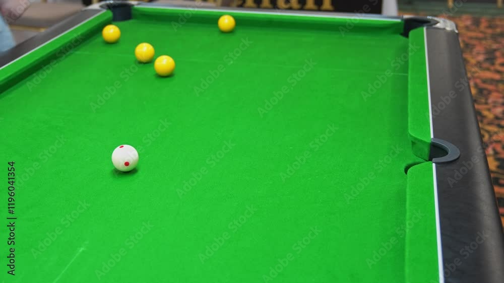 Wining the game by pocketing the black ball in blackball Pool game on a green cloth pool table, hit by the cue pocketing