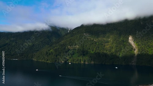 Aerial View of Foggy Mountain Lake with Boats and Dense Forest