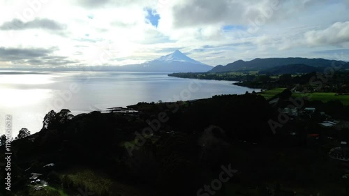 Aerial View of Serene Mountain Lake with Distant Volcano at Sunrise