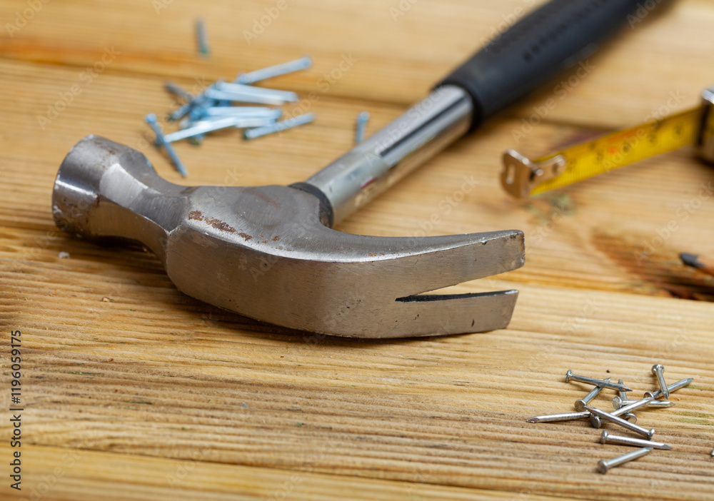 Hand hammer for building works on wooden table, nobody Hand hammer for building works on wooden table, nobody