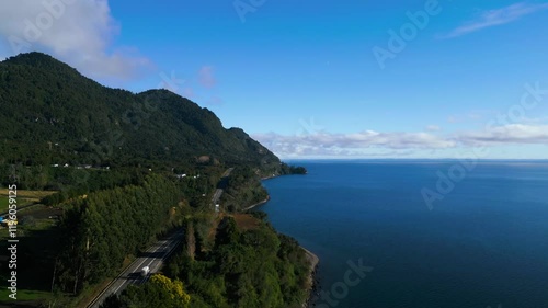 Scenic Coastal Road with Mountain and Ocean View in Clear Weather