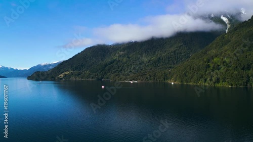 Aerial View of a Tranquil Lake with Boats and Mountain Landscape