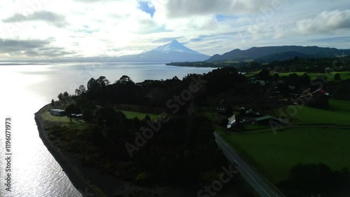 Majestic Aerial View of Snow-Capped Volcano and Pristine Lake