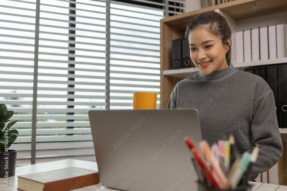 Fototapeta premium happy woman working on laptop at home office, entrepreneur using laptop at home office, mature businesswoman working from home, beautiful company owner working during isolation period