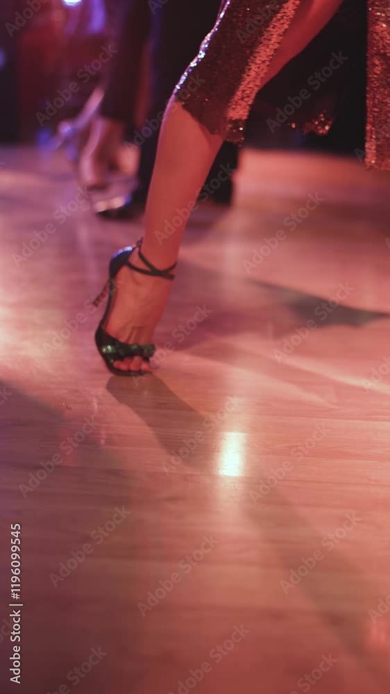 Couples dancing traditional latin argentinian dance milonga in the ballroom, tango salsa bachata kizomba lesson in red and purple lights, evening dance school class festival, performance rehearsal
