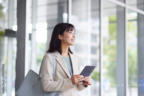 オフィスから出発する日本人ビジネスウーマン