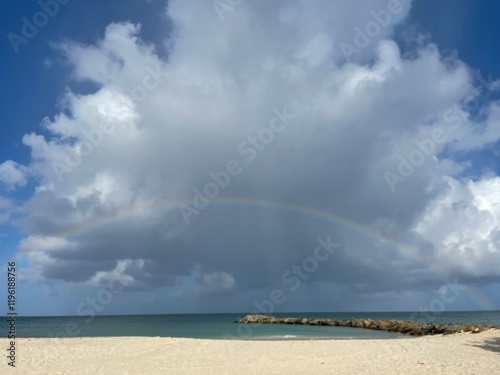 Scenic beach with rainbow and dramatic clouds