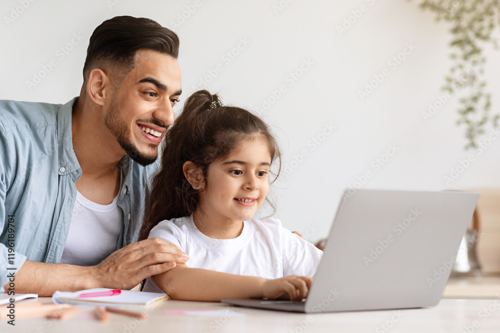 Happy arab man father helping his cute little daughter with homework, sitting together in front of laptop at kitchen, taking notes and smiling, copy space. E-education, home schooling concept Happy arab man father helping his cute little daughter with homework, sitting together in front of laptop at kitchen, taking notes and smiling, copy space. E-education, home schooling concept