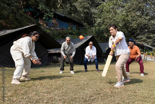 senior citizens playing cricket match at camping side 