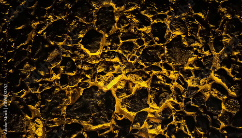 black rock and yellow neon rock floor texture, black background