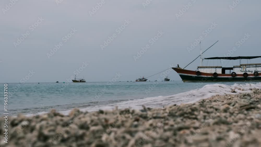 see several boats with waves crashing on shore see several boats with waves crashing on shore