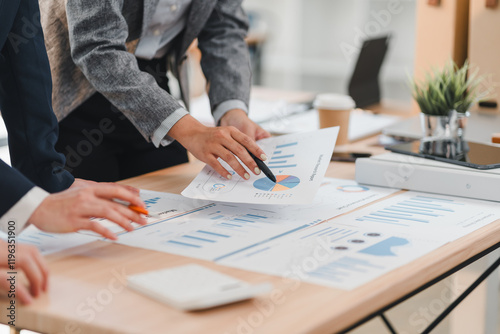 Wallpaper Mural group of business professionals analyzing financial charts and graphs during meeting, focusing on data driven strategies and teamwork in modern office setting Torontodigital.ca