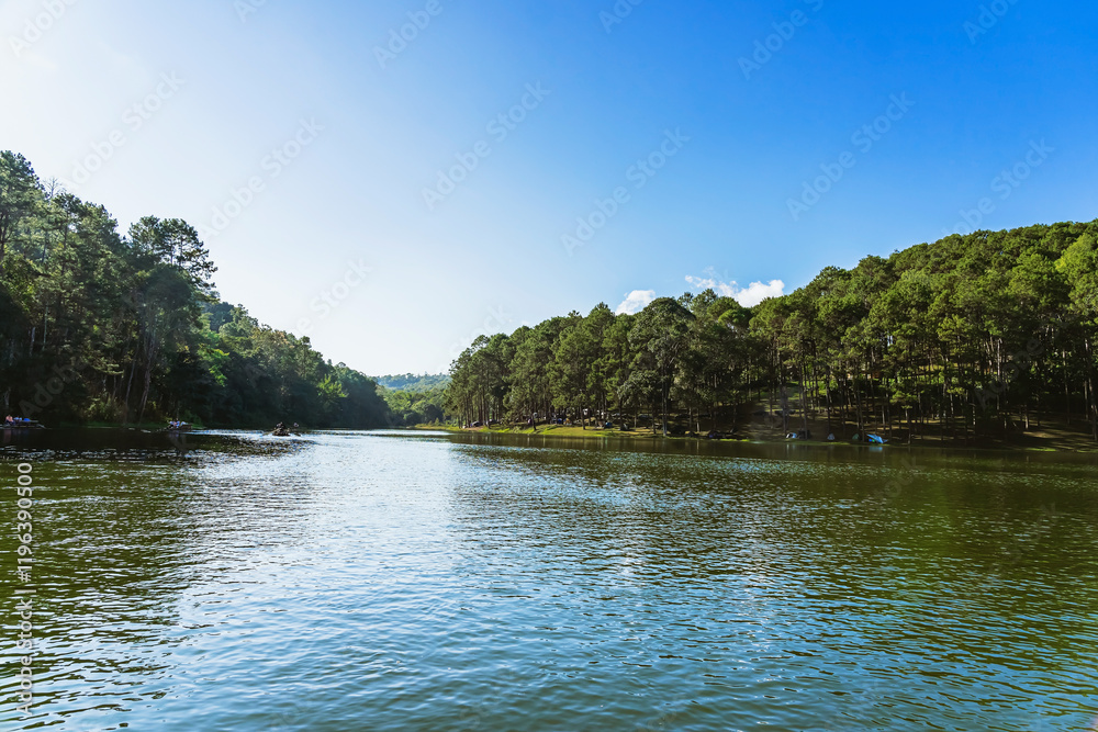 Beautiful destination nature lake and forest of Pang Oung lake and pine forest in Mae Hong Son, Thailand. Nature landscape. Environmental friendly outdoor activity and camping surrounded by valley.