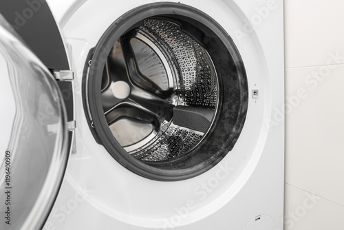 Modern washing machine in light bathroom, closeup photo